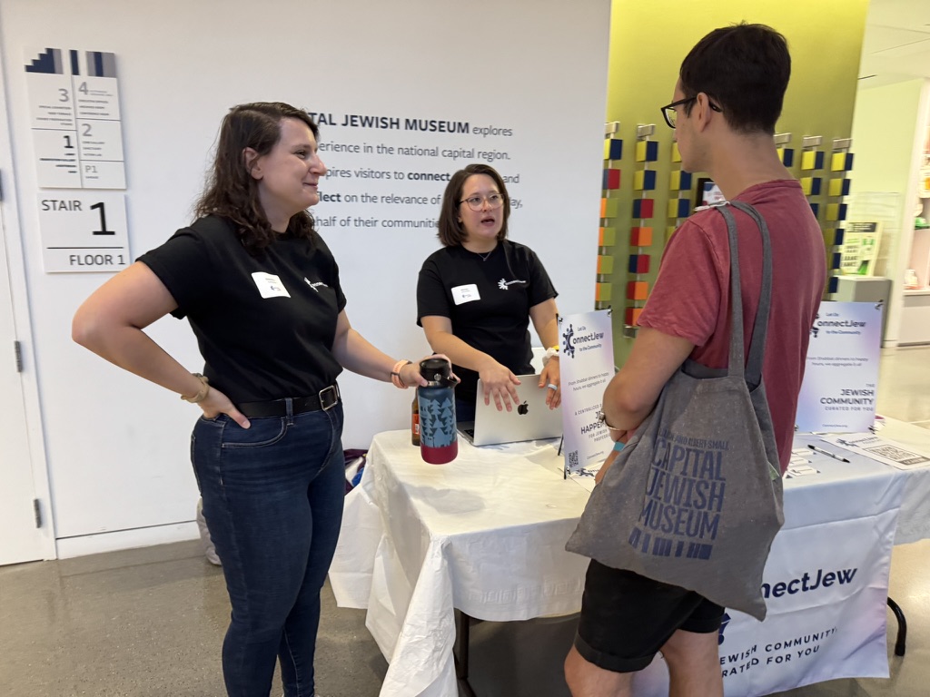 People talking with the ConnectJew team at their ConnectJew LIVE! booth